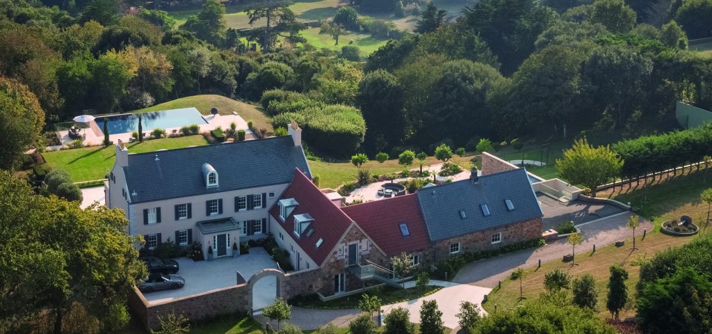 Aerial shot of property in Guernsey with swimming pool.